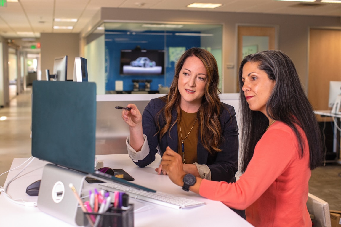 Two Kervon colleagues reviewing an app build at a desk
